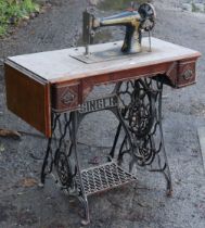 A vintage Singer treadle sewing machine in an oak case, & on a black painted cast-iron base, 88cm
