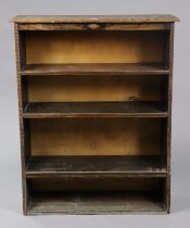 An Edwardian mahogany small upright cupboard with a blind fret-work frieze, having three shelves