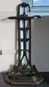 A Victorian-style black painted case-iron umbrella stand 58cm high; an early 20th century mantel