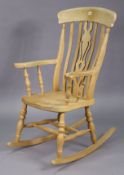 A beech splat-back rocking chair with a hard seat, & on turned supports, with spindle stretchers.