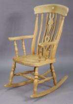 A beech splat-back rocking chair with a hard seat, & on turned supports, with spindle stretchers.