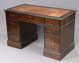 A reproduction mahogany pedestal desk inset gilt-tooled crimson leather, fitted with arrangement