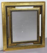 A 19th century-style large guilt frame rectangular wall mirror with a rope-twist border & inset with