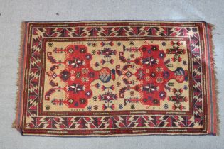 A Persian rug of madder ground, with central medallion in geometric borders,
