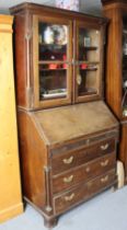 A Late 19th/early 20th century mahogany bureau-bookcase the upper part with two fitted shelves &