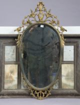 An ornate gilt frame oval wall mirror, 106cm x 58cm; & a wooden-frame triple-panel overmantel mirror