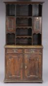 A 19th century oak small dresser the upper part with an arrangement of open shelves & with a small