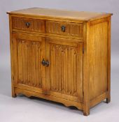A small oak side cabinet fitted two frieze drawers above a pair of linen-fold panel doors, 95cm wide
