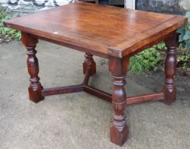 A rosewood dining table with a rectangular top, & on four bulbous-turned legs with diagonal