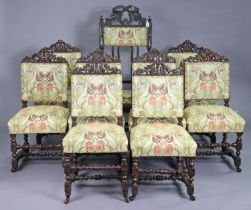 A set of nine 19th century carved oak dining chairs (including one carver) each with a padded seat &