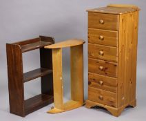 A pine small upright chest fitted six long drawers with turned knob handles, & on a shaped plinth