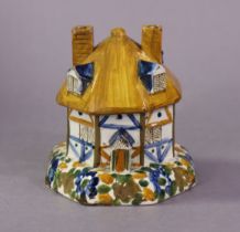 A 19th century Staffordshire pottery box & cover in the form of a thatched cottage, painted in