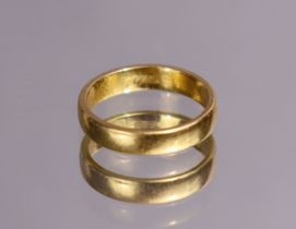 A 22ct. gold wedding band; size: N; 5.1gm.