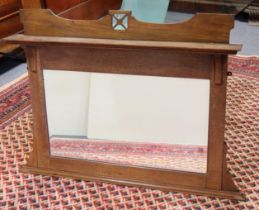 An early 20th century Arts & Crafts style oak overmantel mirror, with shaped & pieced cornice above