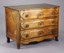 A late 18th/early 19th century French provincial walnut commode of serpentine shape, fitted three