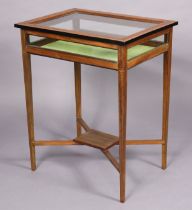 An Edwardian inlaid-mahogany bijouterie table with glazed lift-lid & sides, inset green baize to the