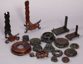 A collection of various Chinese hardwood vase stands, plate stands, covers, etc. with carved &