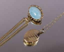 A 14k oval pendant set pale blue hardstone cabochon to one side, amber to the other, on gilt-metal