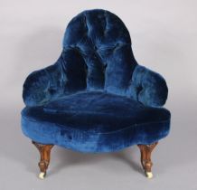 A Victorian walnut nursing chair with shaped buttoned-back & padded seat upholstered blue velour,