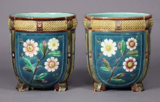 A pair of late 19th century Wedgwood majolica jardinieres, each with relief-moulded floral