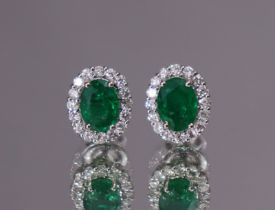 A PAIR OF EMERALD & DIAMOND EARRINGS; the oval-cut emeralds with a combined weight of approx. 2.48