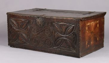 A 17th century oak boarded box with carved stylised motifs to the front & polychrome painted