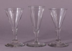 A pair of 18th century English drinking glasses, each with conical bowl on plain short stem &