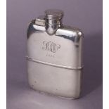 A George V silver pocket spirit flask of curved profile, with hinged screw cap, & removable cup