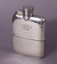 A George V silver pocket spirit flask of curved profile, with hinged screw cap, & removable cup