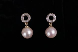 A pair of cultured pearl & diamond drop earrings, the pearls approx. 8mm dia., each suspend from a