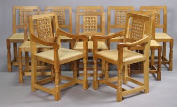 ROBERT THOMPSON OF KILBURN: A SET OF 10 ‘MOUSEMAN’ OAK DINING CHAIRS, including a pair of carvers,