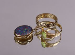 An 18ct. gold ring set oval-cut peridot, size: O/P (3.8gm); an un-marked yellow metal eternity