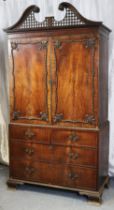 An 18th century Chippendale-style figured mahogany linen press, with pierced quatrefoils & carved