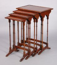 A mid-20th century yew wood nest of four occasional tables in the regency style, on slender turned
