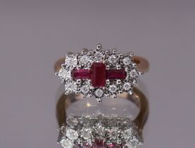 A RUBY & DIAMOND RING set three central baguette-cut rubies within a border of small round-cut