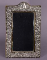 An Edwardian silver table mirror with easel support inset rectangular bevelled plate, the wide