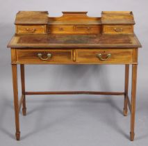 An Edwardian inlaid-mahogany writing desk inset tooled leather top, fitted an arrangement of six