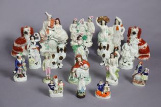 A collection of 18 various Staffordshire pottery flat-back figures, groups, model spaniels, etc. (