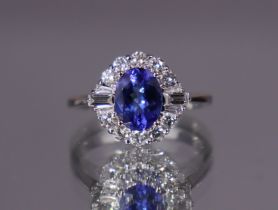 A tanzanite & diamond ring, the oval-cut centre stone weighing approx. 1.29 carats, set within a