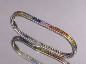 A white 14k ‘rainbow sapphire’ flexible bracelet set continuous row of rectangular-cut stones; 18.