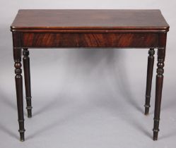 A Georgian mahogany tea table with rounded corners to the rectangular fold-over top, on turned