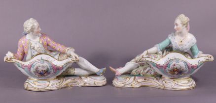 A pair of Meissen (dot period) porcelain figural sweetmeat dishes, modelled as a romantic male &