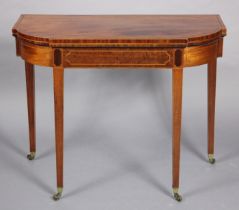 An early 19th century inlaid-mahogany break-front demi-lune tea table, with hinged fold-over top, on