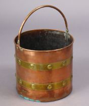 An early 20th century copper & brass-bound cylindrical coal bucket with embossed bands & overhang