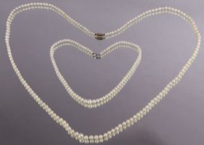 A single-row long necklace of graduated cultured pearls, with 9ct. gold barrel clasp, 92cm; & a