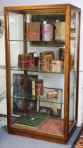 An early/mid-20th century glazed mahogany shop display cabinet fitted three adjustable glass