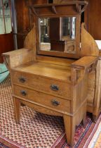 An early 20th century oak dressing chest in the Arts & Crafts style, with rectangular mirror on