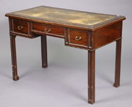 A late 19th/early 20th century mahogany knee-hole writing table inset tooled green leather