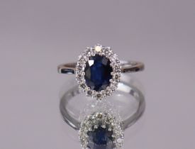 A deep-blue kyanite and diamond ring, the oval-cut centre stone weighing approx. 1.77 carats, set
