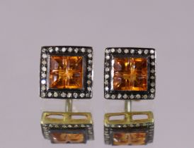 A pair of citrine & diamond cuff-links, each square panel set four square-cut citrines within a